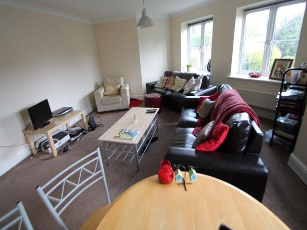 A bright and welcoming living room featuring co...