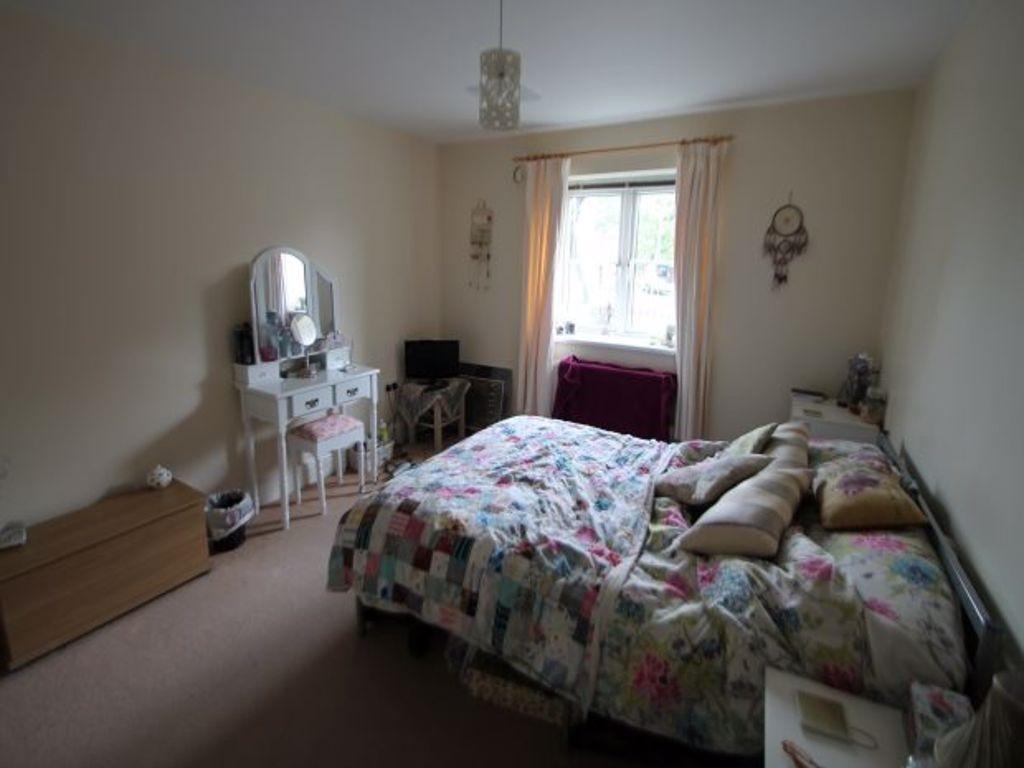 A spacious and cozy master bedroom filled with ...