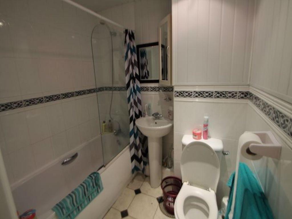 A spacious, well-maintained bathroom with a bat...