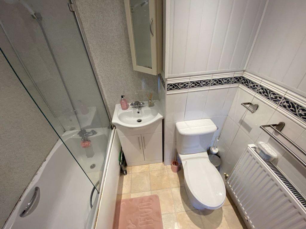 A clean, well-maintained bathroom featuring a t...