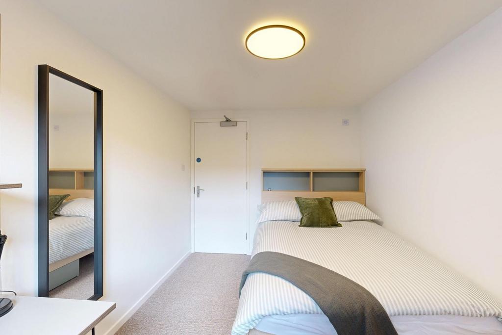A bright and inviting master bedroom featuring ...