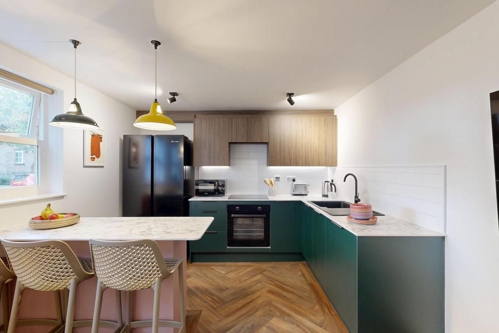 A modern, well-lit kitchen area featuring conte...