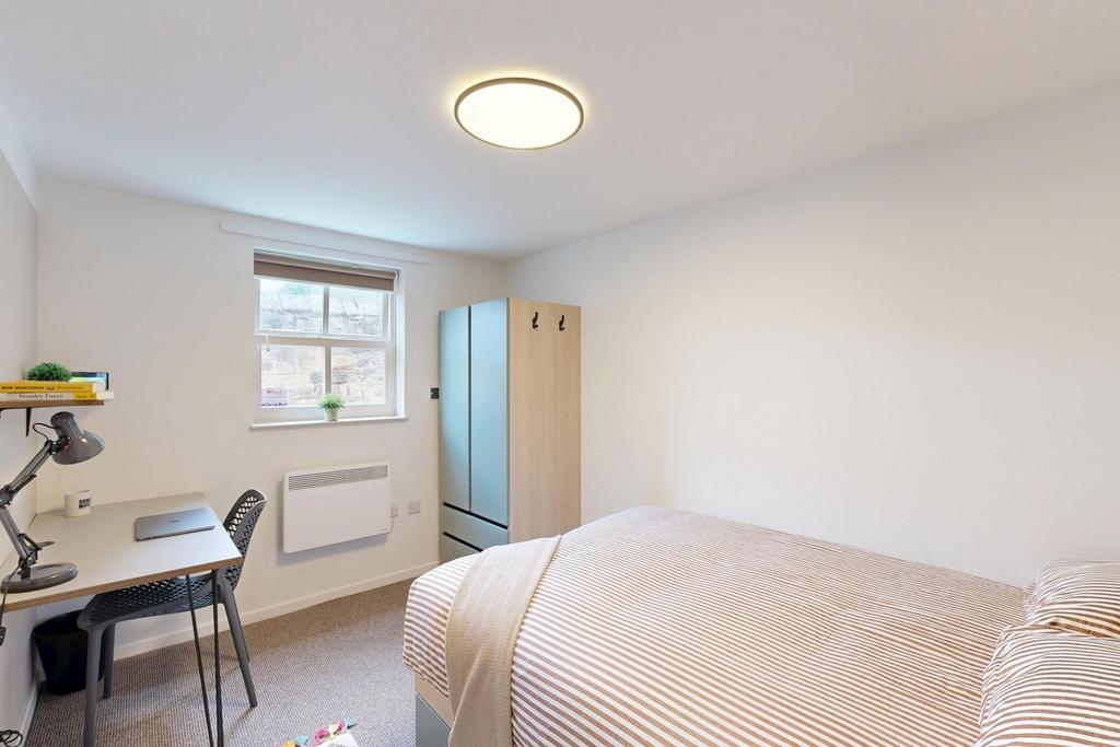 A bright and neatly maintained master bedroom f...