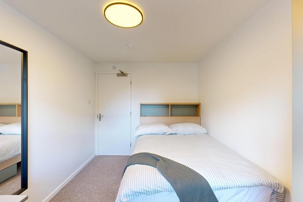 A bright and spacious master bedroom featuring ...