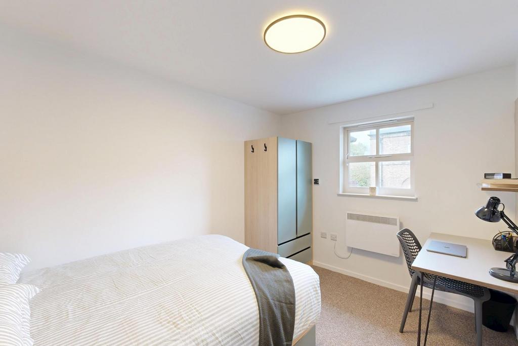 A bright and inviting master bedroom featuring ...
