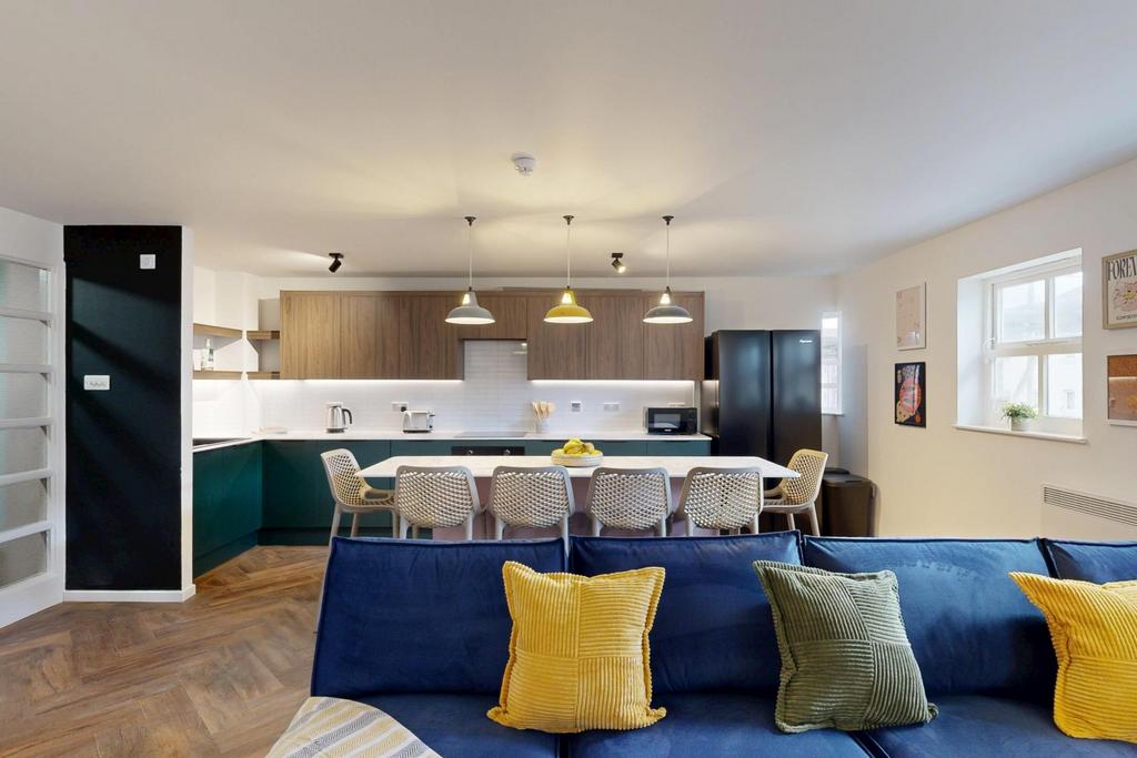 A spacious and well-lit contemporary living roo...