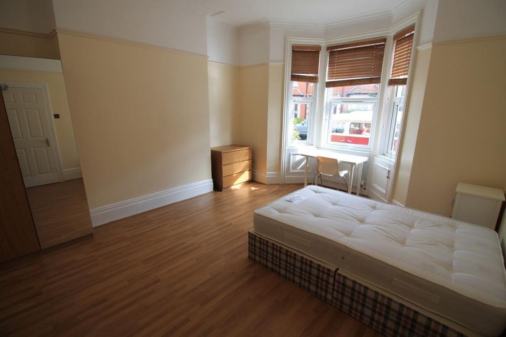 Bright and spacious master bedroom with large w...