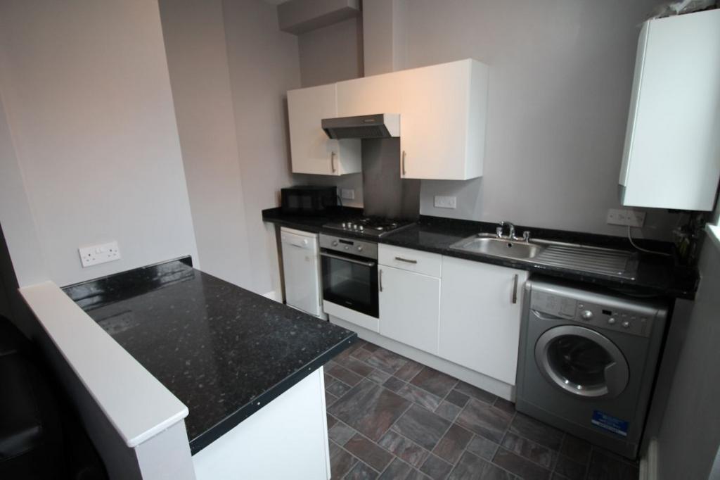 A modern kitchen with ample counter space, whit...