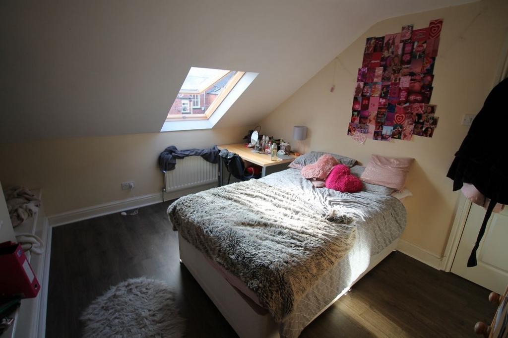 A bright and spacious master bedroom with a lar...