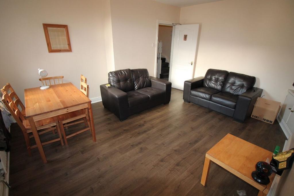 A well-maintained, modern living room featuring...