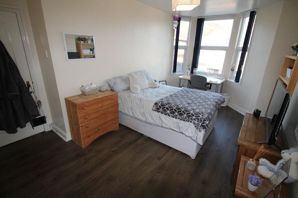 A bright and inviting bedroom featuring a doubl...