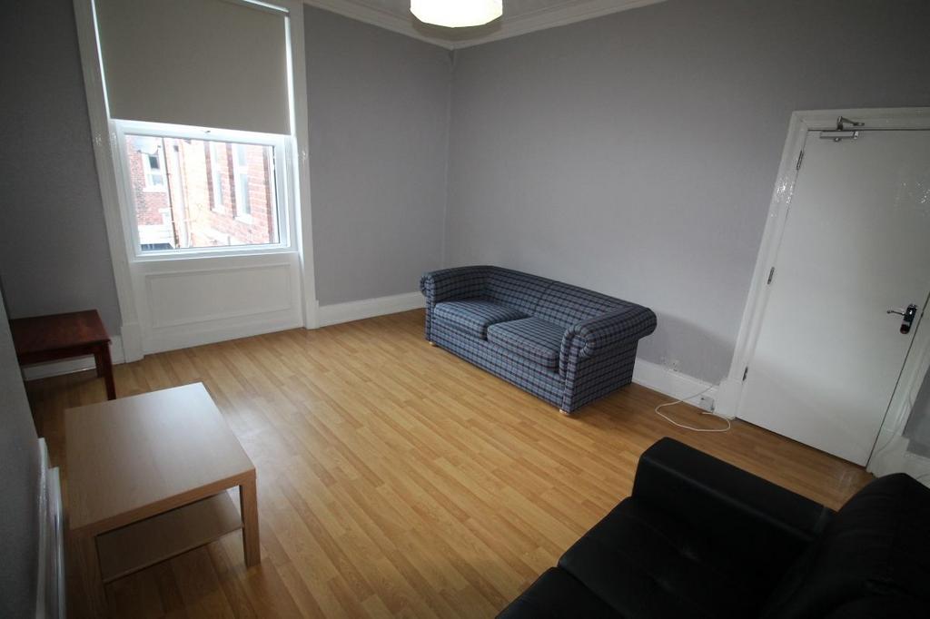 A well-lit, tidy single bedroom with a comforta...