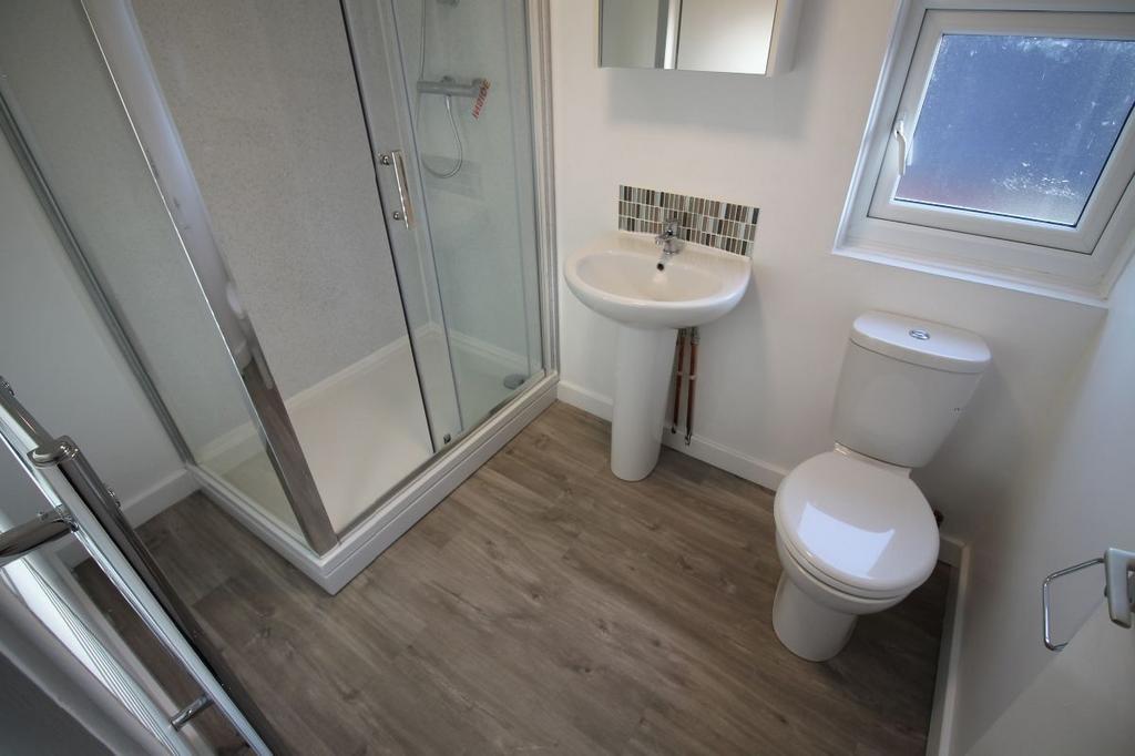 A clean and bright bathroom featuring a shower ...