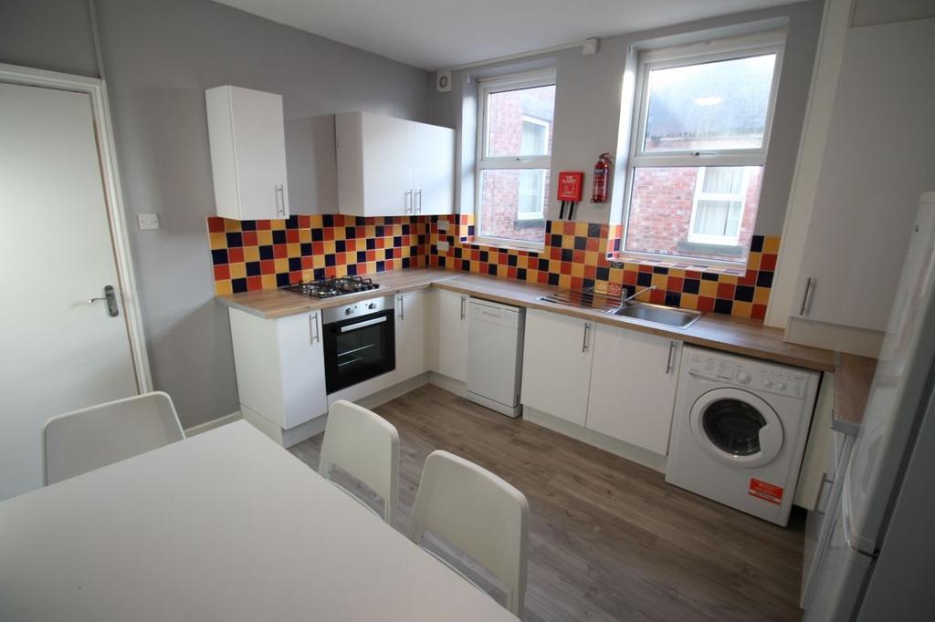 A modern, well-maintained kitchen featuring whi...