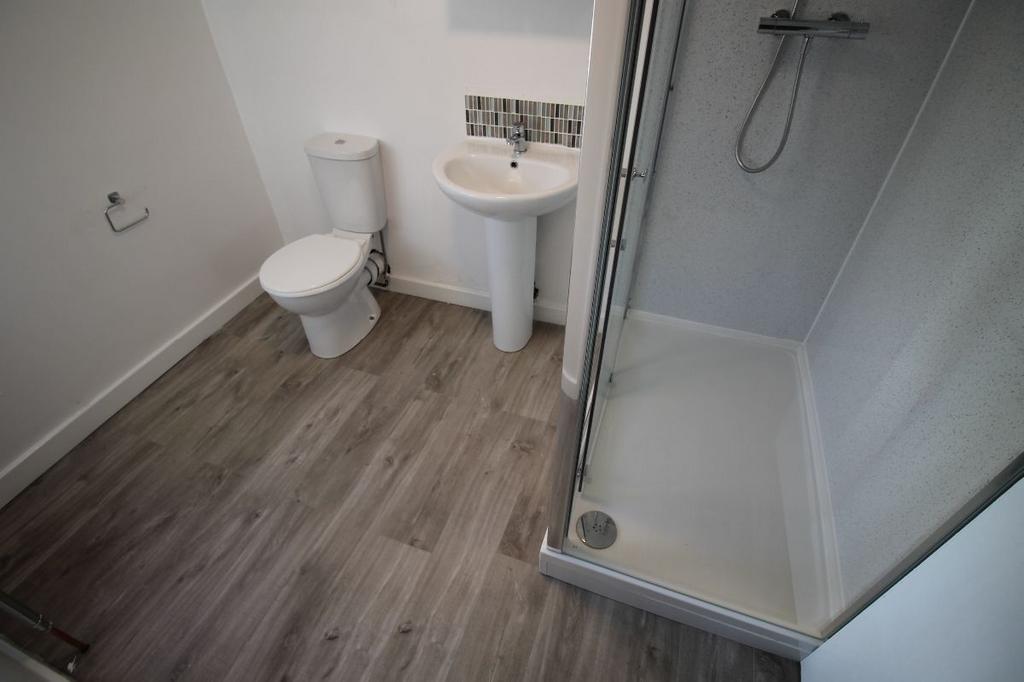 A clean and modern bathroom with a shower enclo...