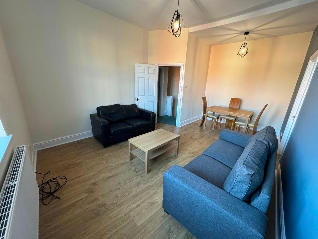 A bright and welcoming living room featuring a ...