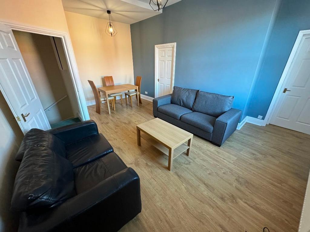 A bright, well-maintained living room featuring...