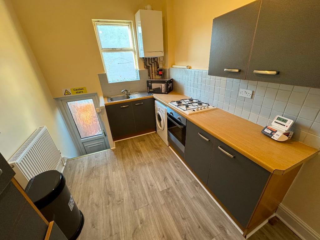 A well-maintained modern kitchen with ample cou...