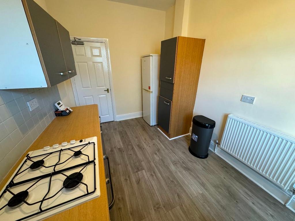 A bright and tidy kitchen space featuring a gas...