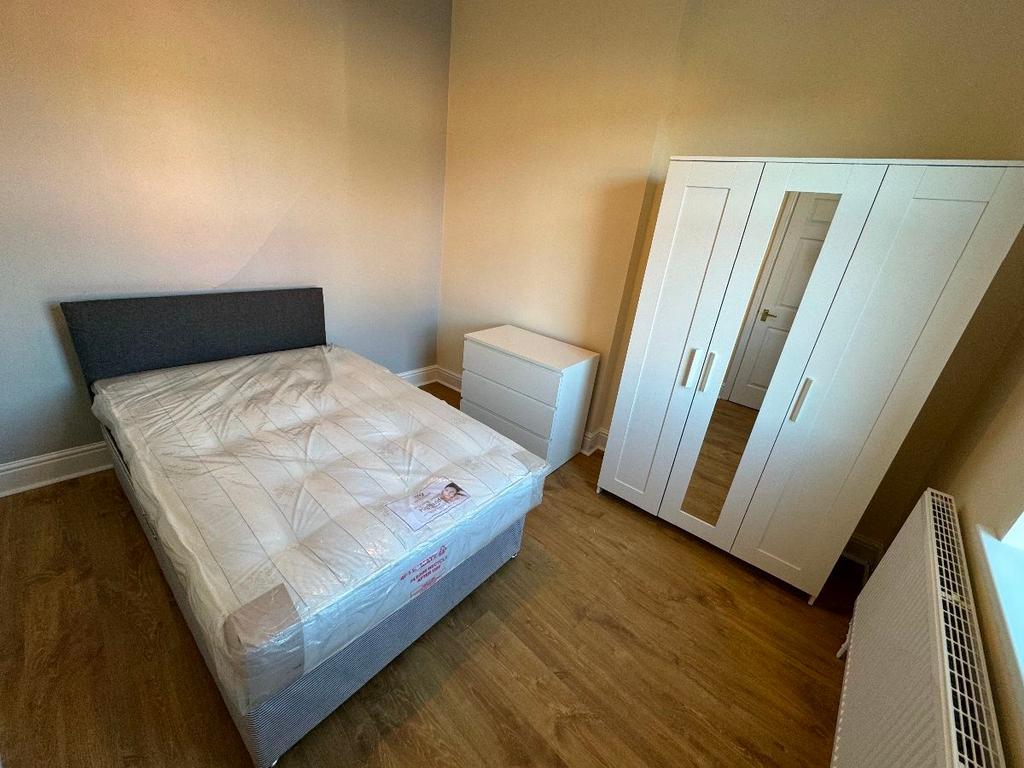 A well-maintained bedroom featuring a comfortab...