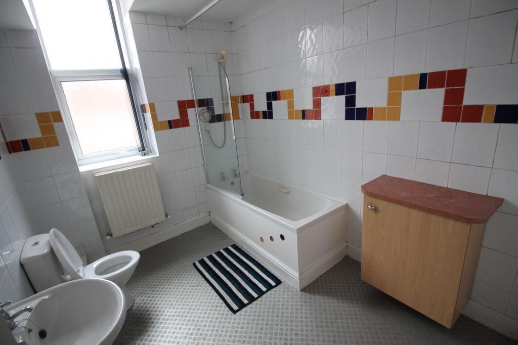 A clean and well-lit bathroom featuring a toile...