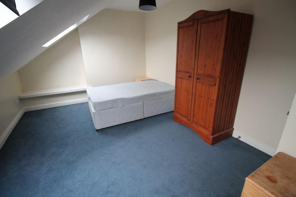 A cozy single bedroom with a simple mattress an...