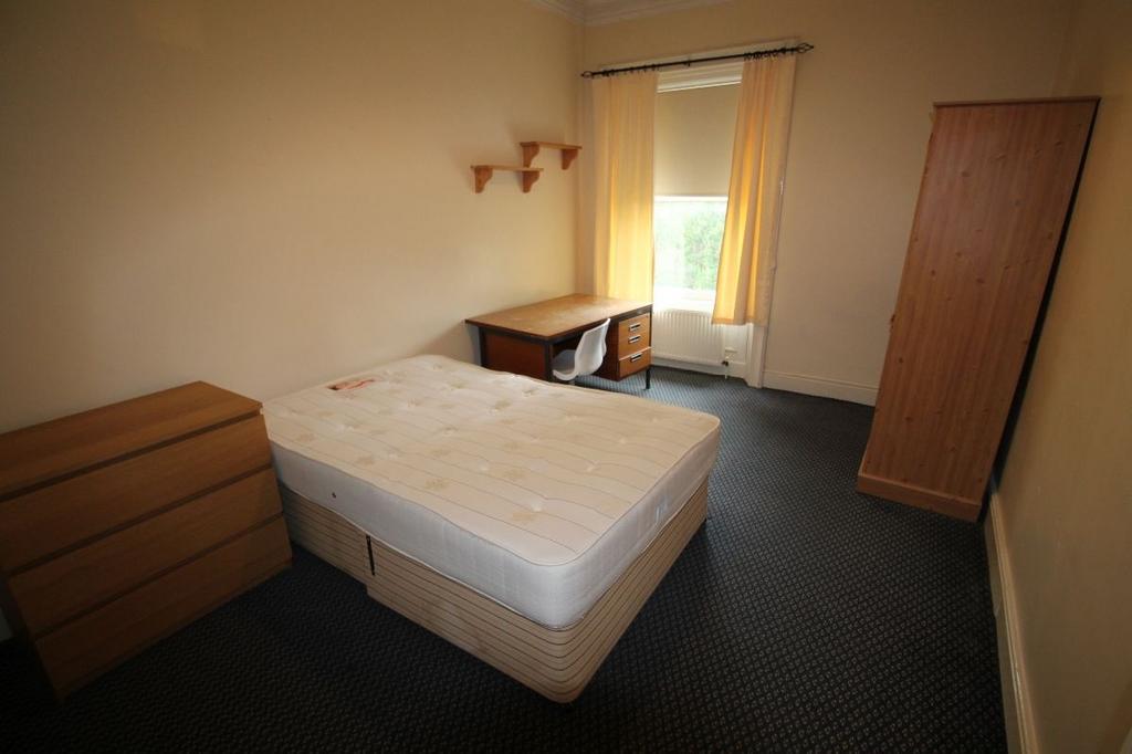 A well-maintained bedroom featuring a window al...