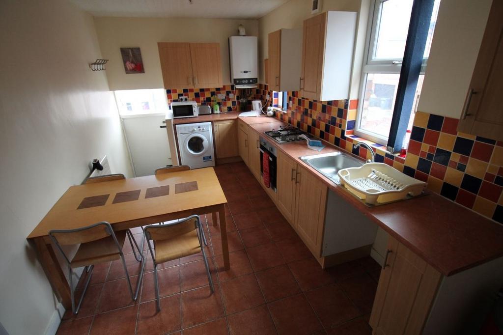A well-maintained kitchen with ample natural li...