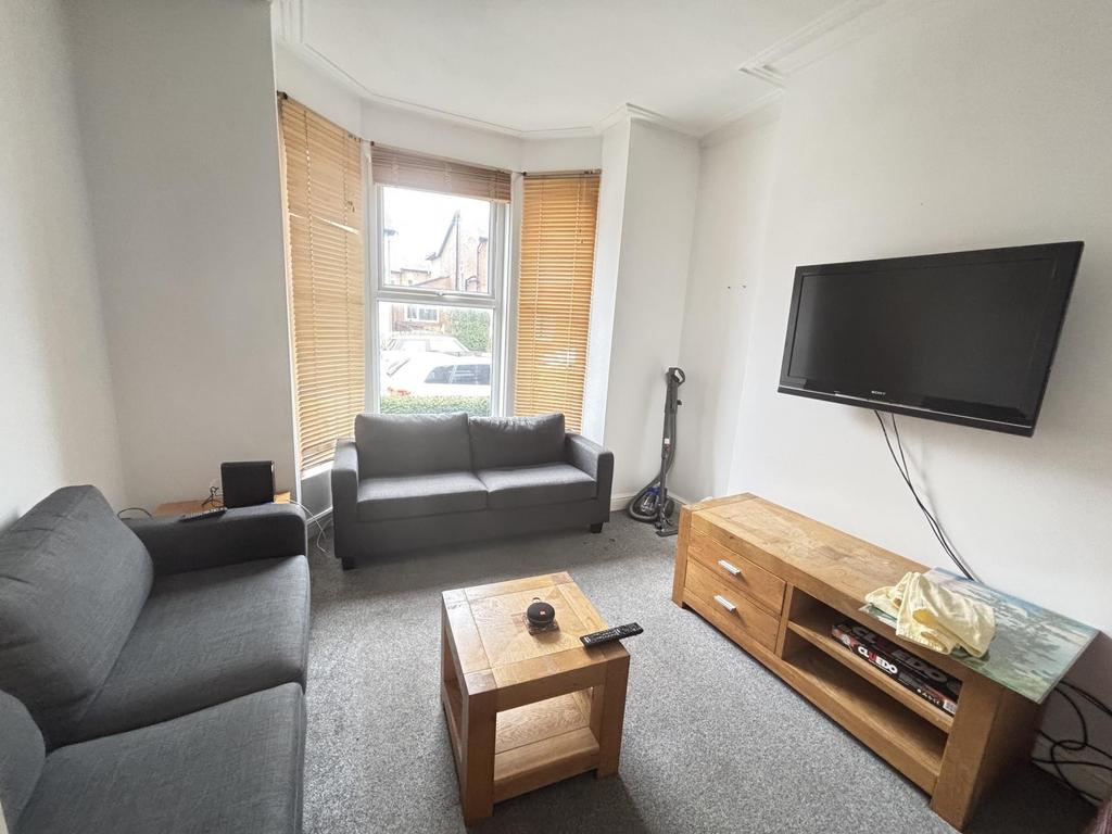 Bright, well-presented living room with a bay w...