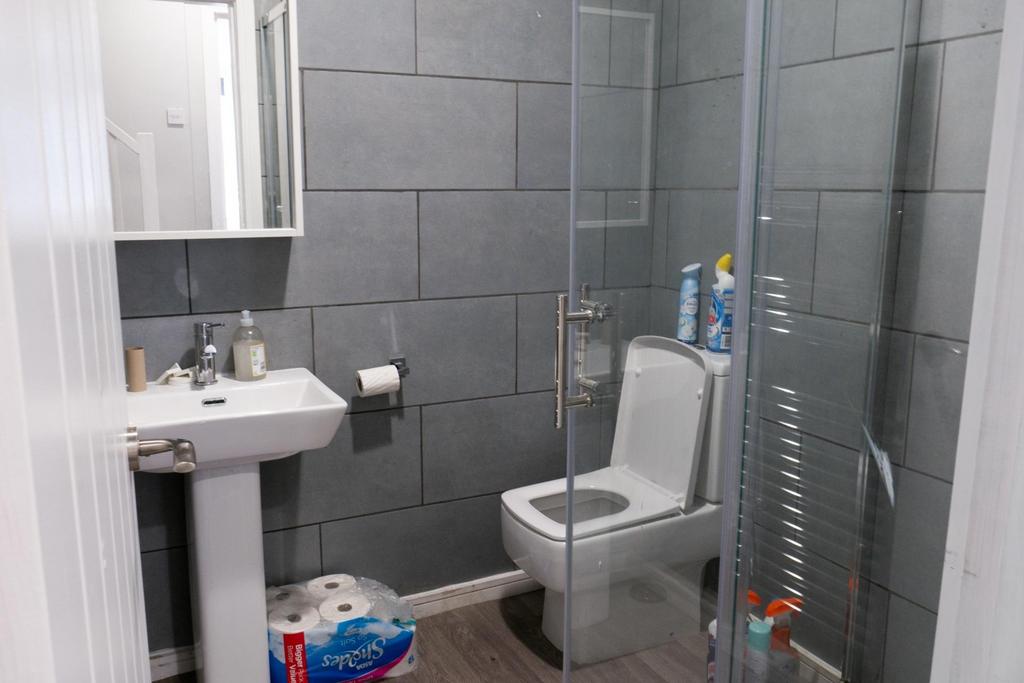 A modern and tidy bathroom featuring a large to...