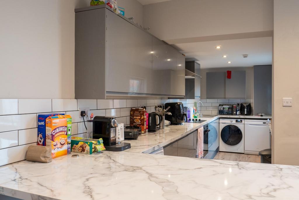 Modern kitchen with a clean marble countertop, ...