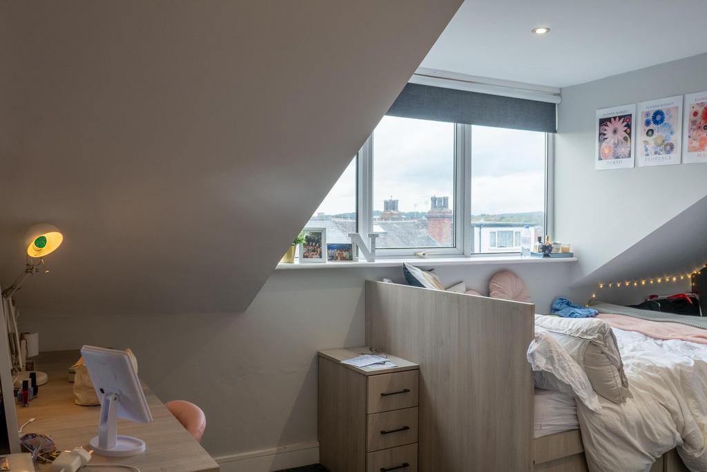 A cozy bedroom with ample natural light coming ...