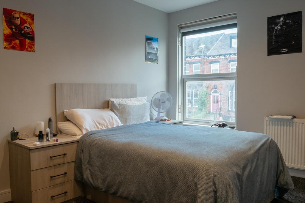 A well-maintained bedroom with a comfortable do...