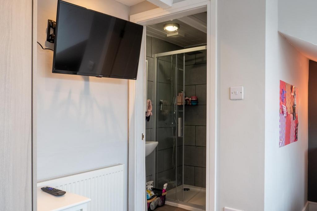 A modern bathroom featuring a glass shower encl...