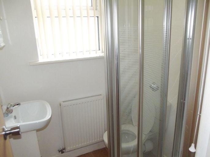 A neatly maintained bathroom with a shower encl...