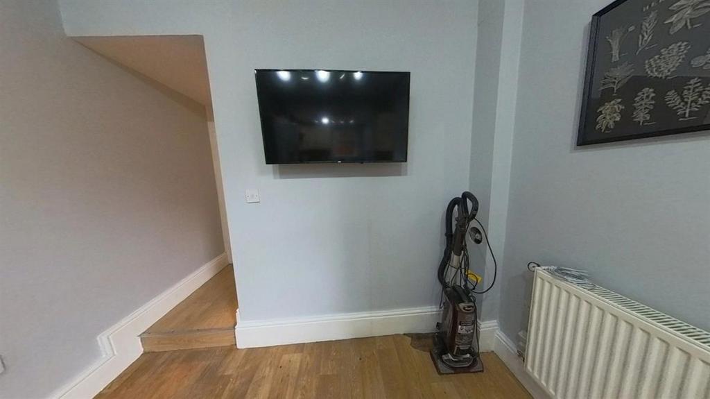 A well-maintained living room with a mounted fl...