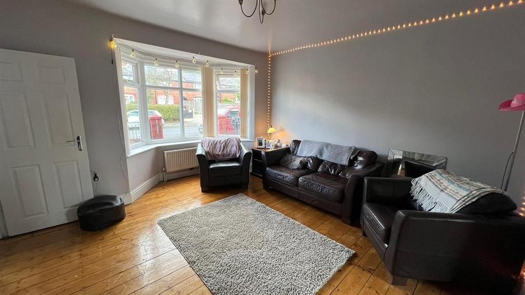 A spacious and inviting living room featuring a...