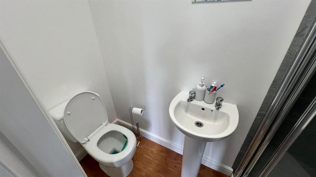 A clean and tidy bathroom with a standard toile...