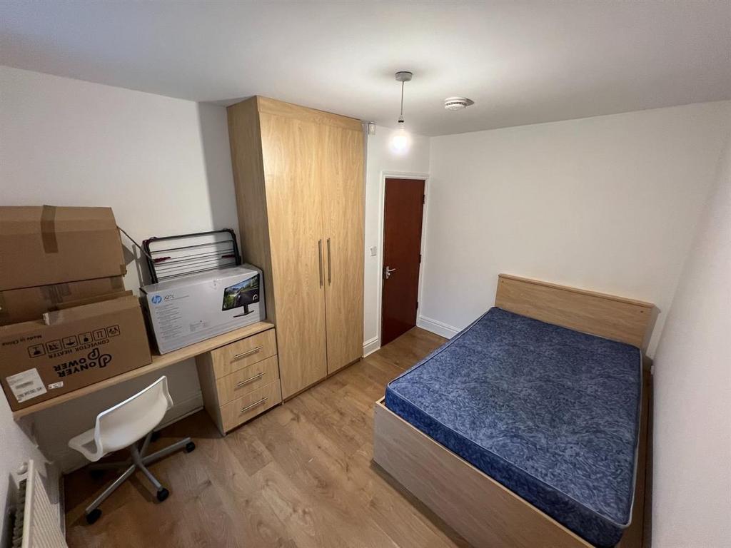 A cozy bedroom featuring a double bed with a bl...