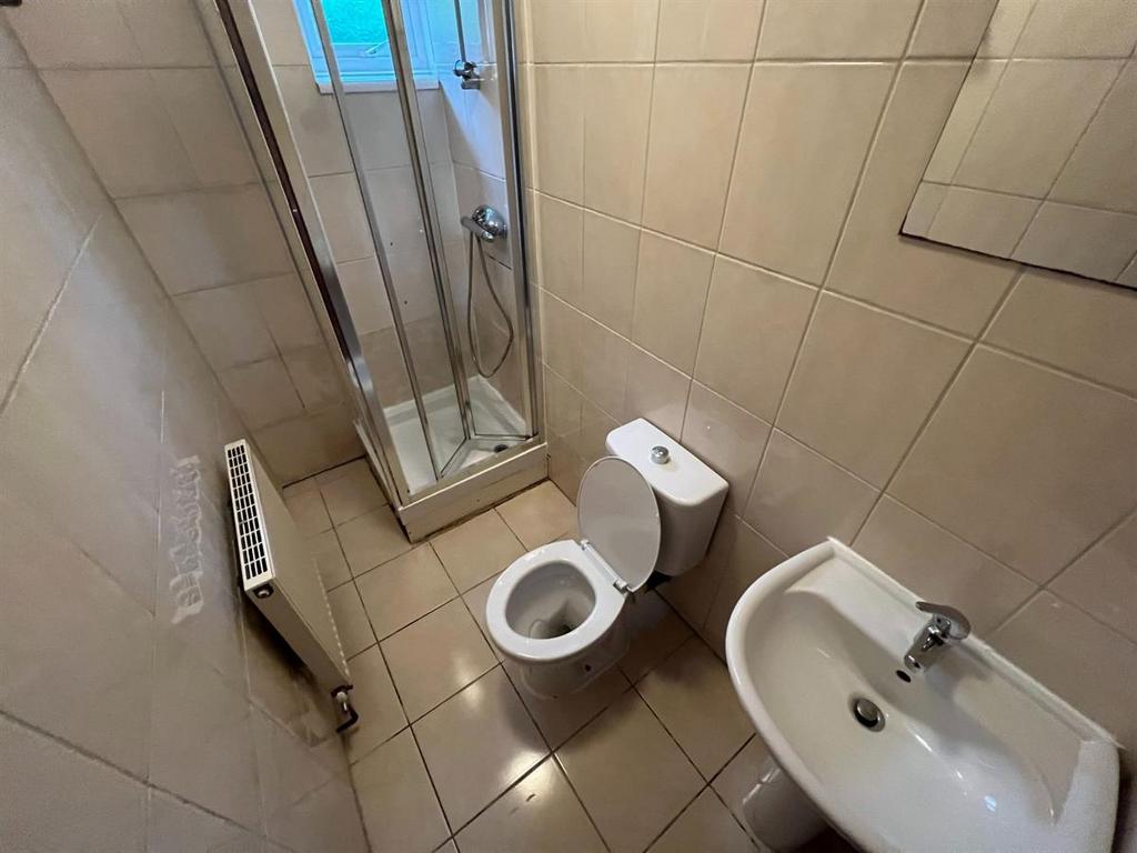 A clean and modern bathroom featuring a toilet,...