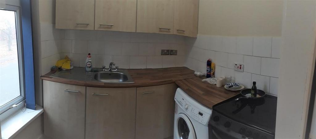 Bright and functional kitchen with ample natura...