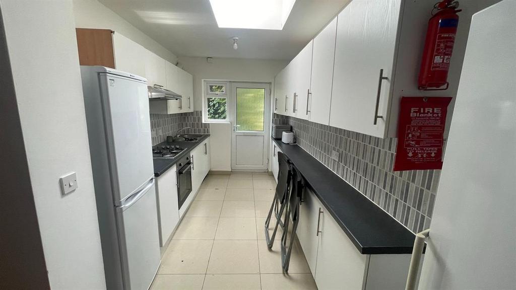 A modern, well-lit kitchen with clean surfaces ...