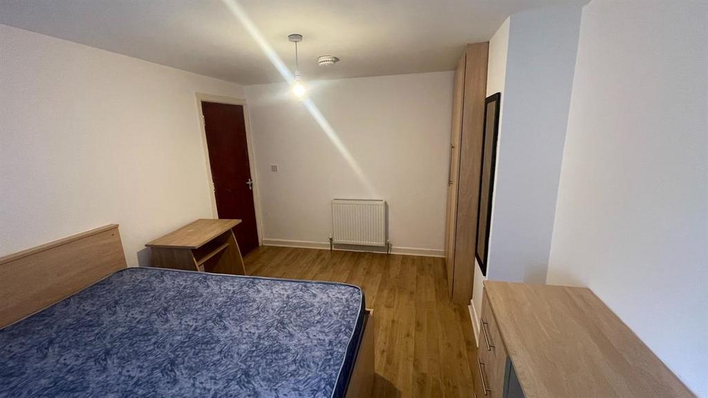 A clean and well-maintained bedroom featuring a...