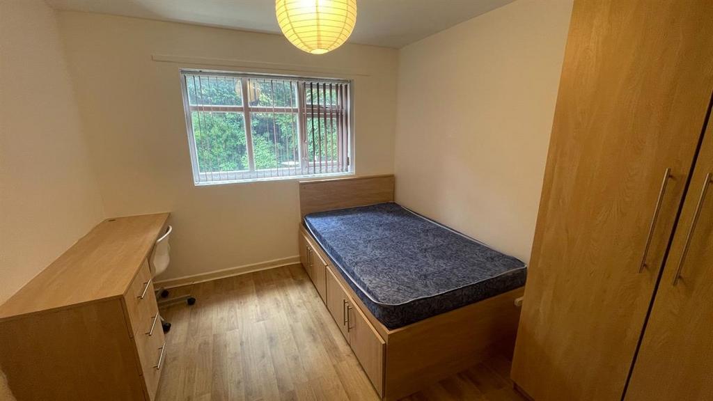 A neatly maintained single bedroom featuring a ...