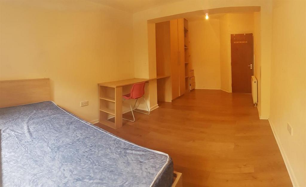 A well-maintained bedroom featuring a comfortab...