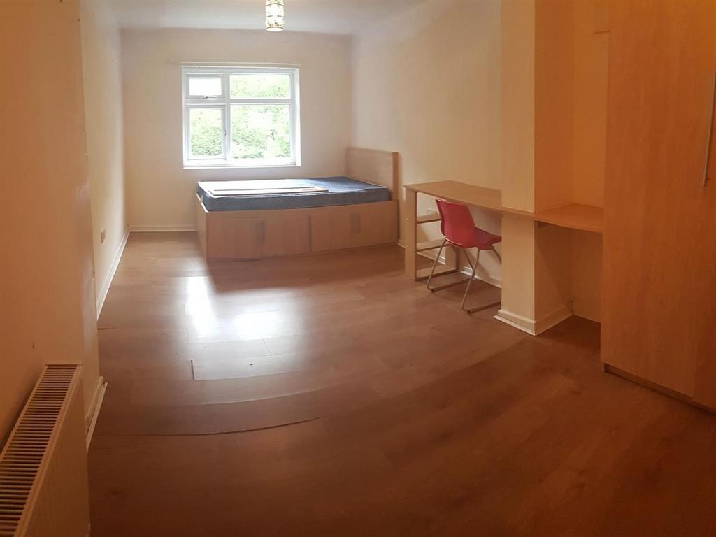 A bright and welcoming bedroom with a built-in ...