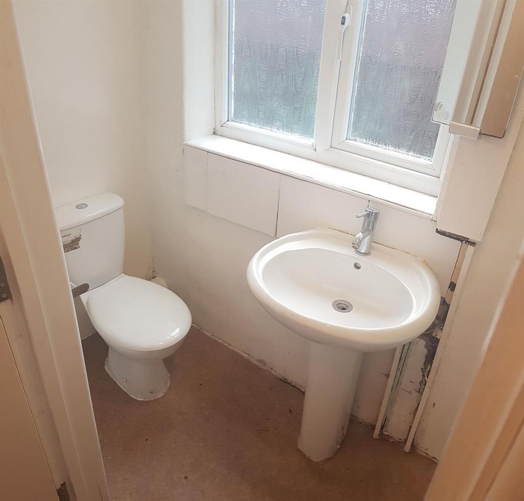 A clean and bright bathroom with a standard toi...