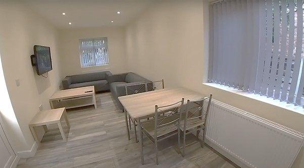 A bright and welcoming living room featuring am...