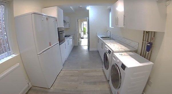 A clean, well-lit kitchen with modern appliance...