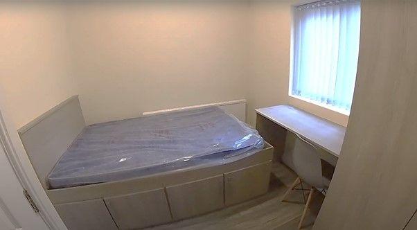 A cozy single bedroom with a comfortable bed an...